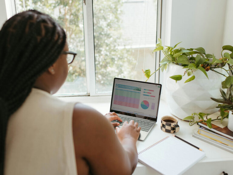 A woman working on her laptop from home