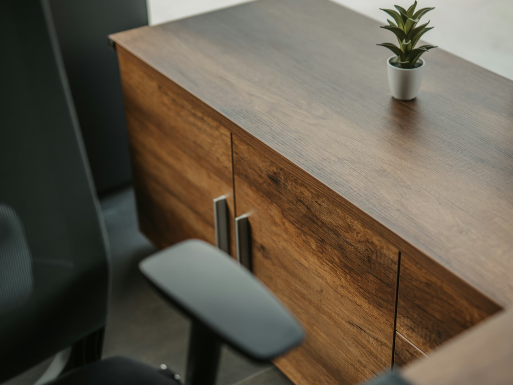 A home office desk and office chair pictured from a top angle